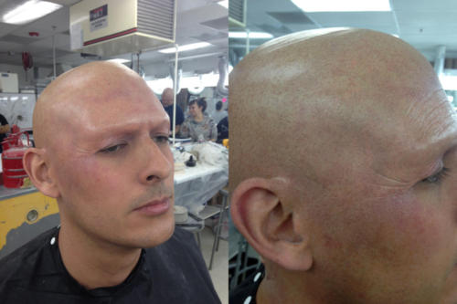 Bald cap, prosthetic forehead, and light aging makeup.